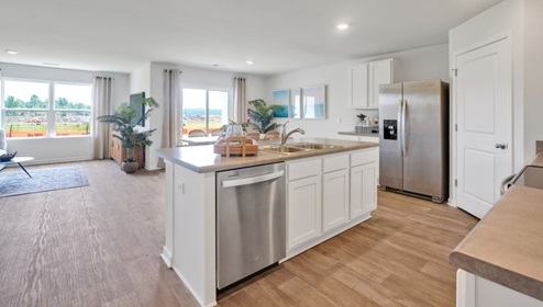 kitchen equipped with Granite countertops, Stainless Steel Appliances, including a smooth-top electric range, microwave, and dishwasher.