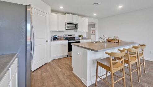 kitchen equipped with Granite countertops, Stainless Steel Appliances, including a smooth-top electric range, microwave, and dishwasher.