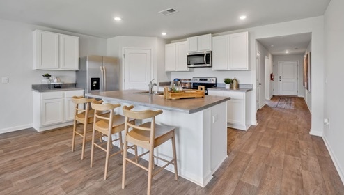kitchen equipped with Granite countertops, Stainless Steel Appliances, including a smooth-top electric range, microwave, and dishwasher.