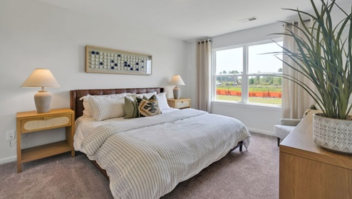 As you enter, you'll find three bedrooms with a shared bathroom, while the Primary Bedroom, off the living area, offers a private ensuite bathroom.