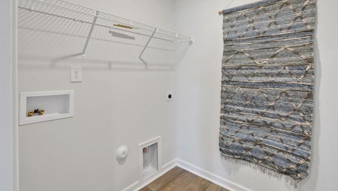 As you enter, you'll find three bedrooms with a shared bathroom, while the Primary Bedroom, off the living area, offers a private ensuite bathroom. This home combines a functional layout with quality finishes, making it a great choice for those seeking a modern ranch-style design.