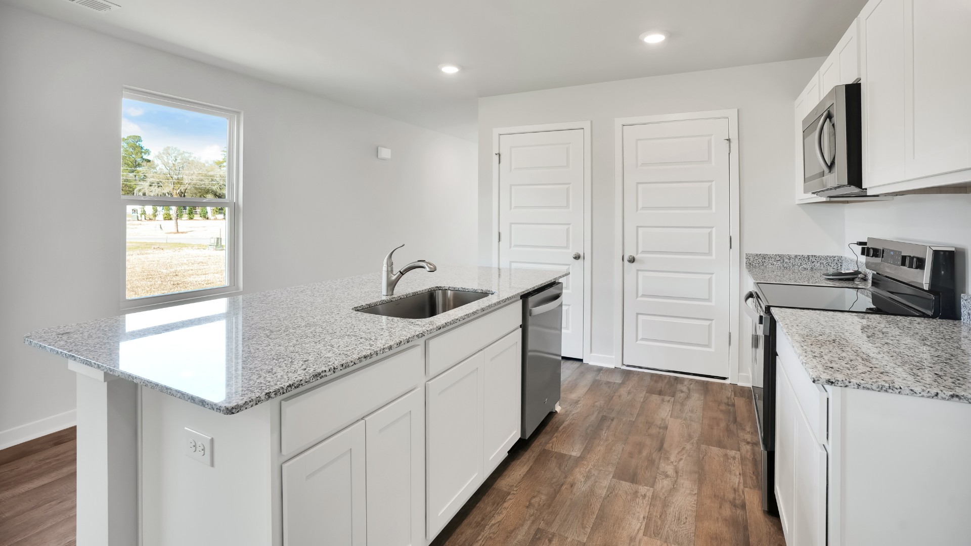 The kitchen features shaker-style cabinets, granite countertops, and stainless-steel appliances, which are sure to both turn heads and make meal prep easy. You’ll never be too far from the action with the living and dining area right there.