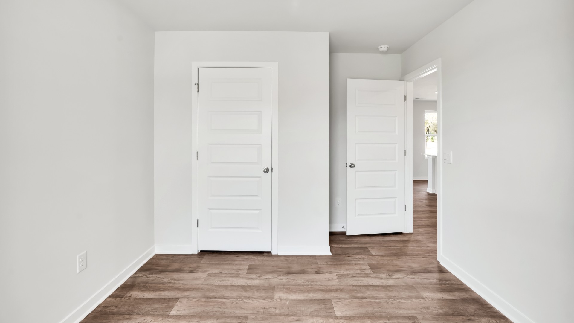 Two other bedrooms share a second bathroom. The laundry room is located at the front of home near the two-car garage, quietly away from living areas and bedrooms. Small covered porch at the front.