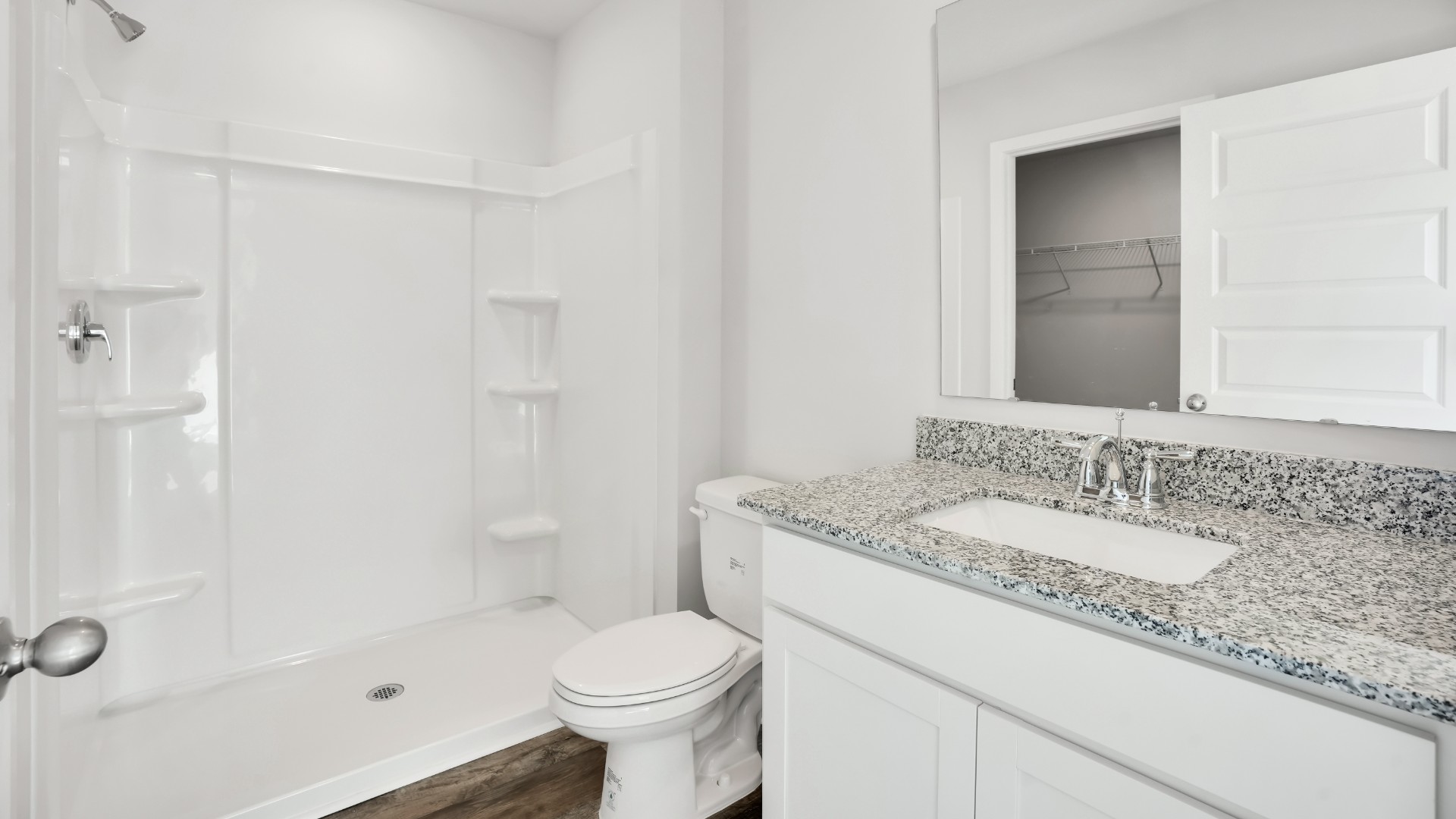 Two other bedrooms share a second bathroom. The laundry room is located at the front of home near the two-car garage, quietly away from living areas and bedrooms. Small covered porch at the front.