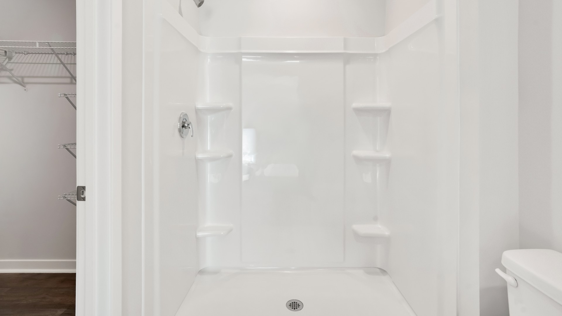 Two other bedrooms share a second bathroom. The laundry room is located at the front of home near the two-car garage, quietly away from living areas and bedrooms. Small covered porch at the front.