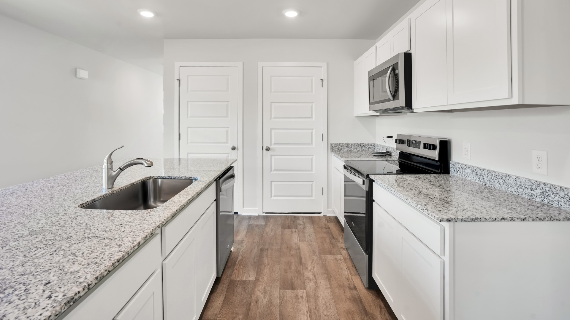The kitchen features shaker-style cabinets, quartz countertops, and stainless steel appliances, which are sure to both turn heads and make meal prep easy. You’ll never be too far from the action with the living and dining area right there.