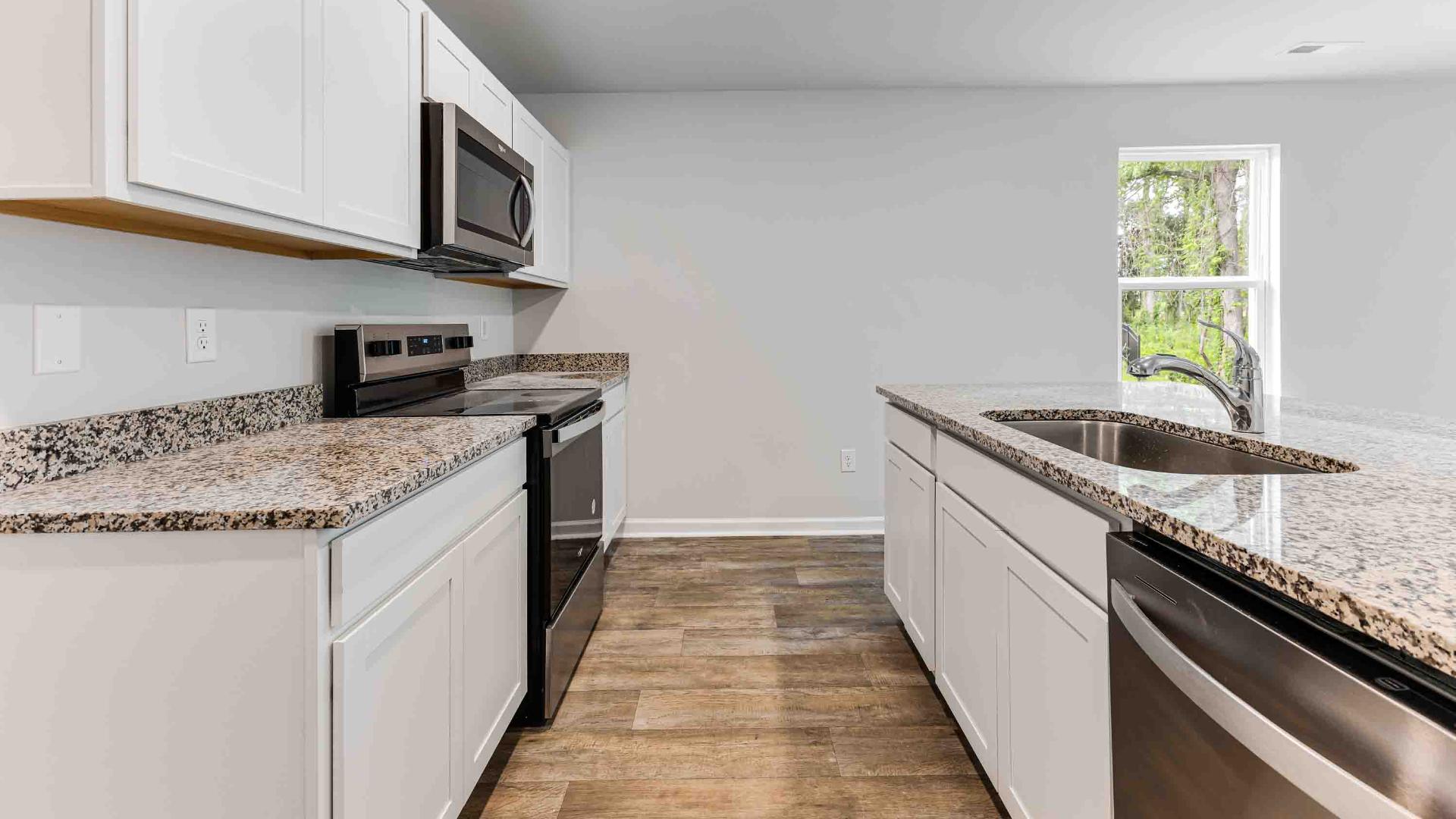 Stainless Steel Appliances in the well thought out kitchen with granite countertops in the kitchen and a large island that is perfect for entertaining. You’ll never be too far from the action with the living and dining area right there.