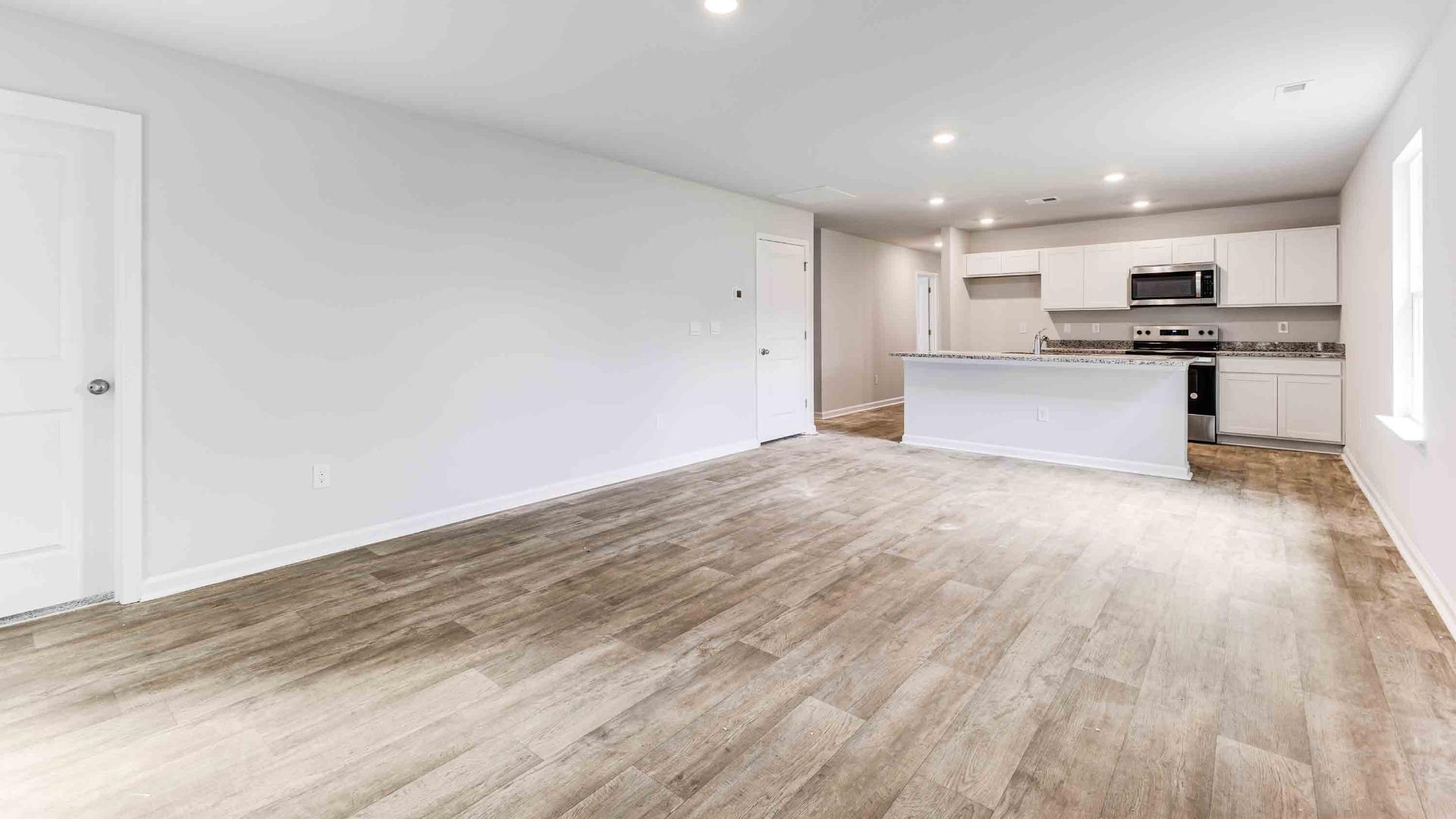 Stainless Steel Appliances in the well thought out kitchen with granite countertops in the kitchen and a large island that is perfect for entertaining. You’ll never be too far from the action with the living and dining area right there.