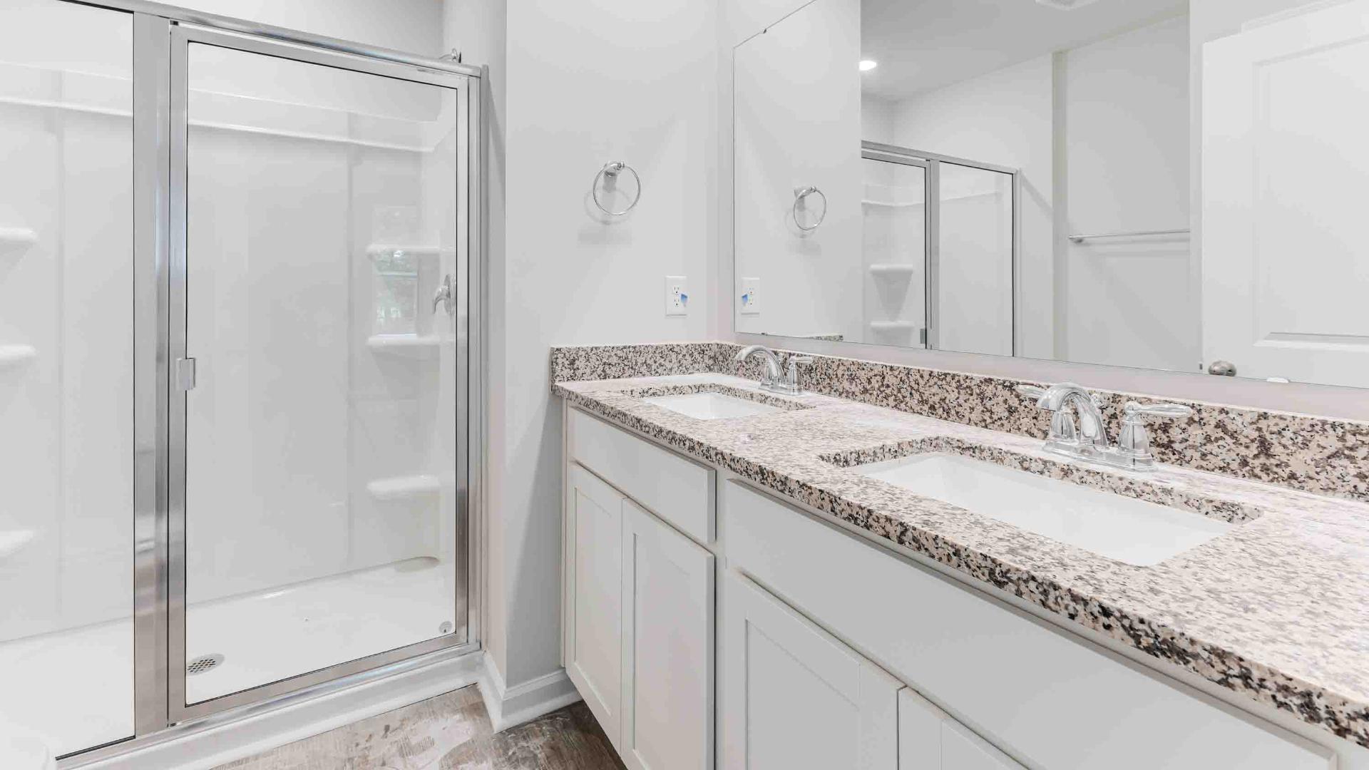 The two bathrooms feature granite countertops. The primary suite has a spacious bedroom with a walk in closet, and the bath has a walk in shower. Architectural shingles, garage door opener, and screens on all windows!