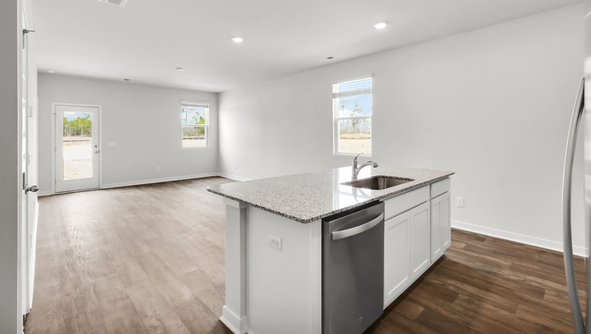 The kitchen features shaker-style cabinets, granite countertops, and stainless steel appliances, which are sure to both turn heads and make meal prep easy