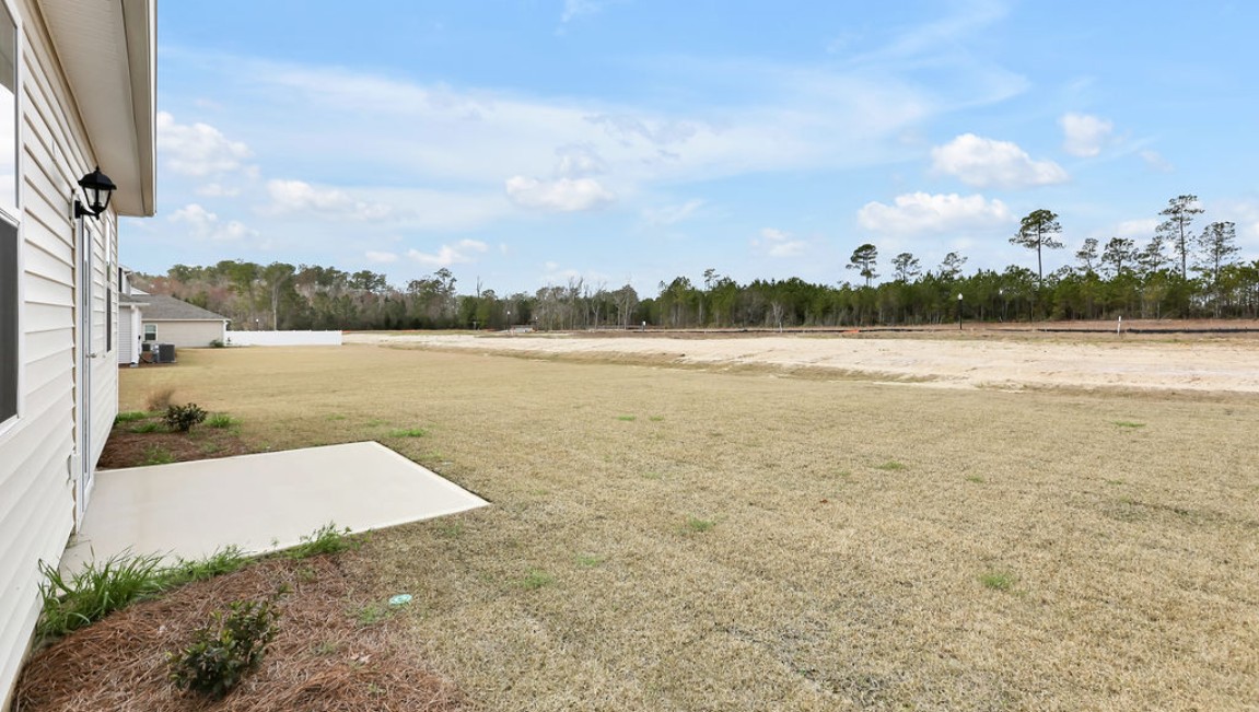 The Curtis is a three-bedroom, two-bathroom floor plan designed for modern living.It features an open-concept layout, where the kitchen comes with stainless steel appliances and a sleek peninsula countertop that overlooks the spacious living room, creating a great space for entertaining or relaxing. To the left of the front door, you'll find two bedrooms, a shared bathroom, and a convenient laundry room. At the back, the owner's suite offers a walk-in closet, a dual vanity, and a luxurious walk-in shower. If you're looking for a stylish and functional new home, the Curtis is a perfect choice. Enjoy the patio perfect for entertaining and enjoying the Carolina nights.