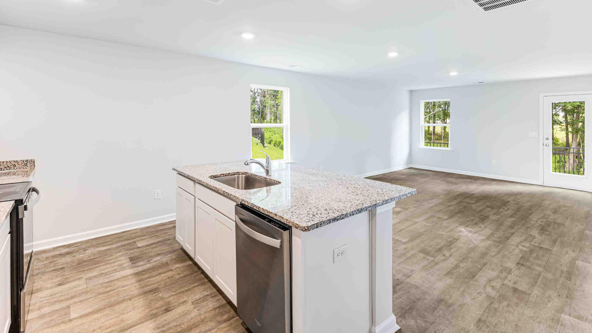 The kitchen features shaker-style cabinets, granite countertops, and stainless steel appliances, which are sure to both turn heads and make meal prep easy. You’ll never be too far from the action with the living and dining area right there.