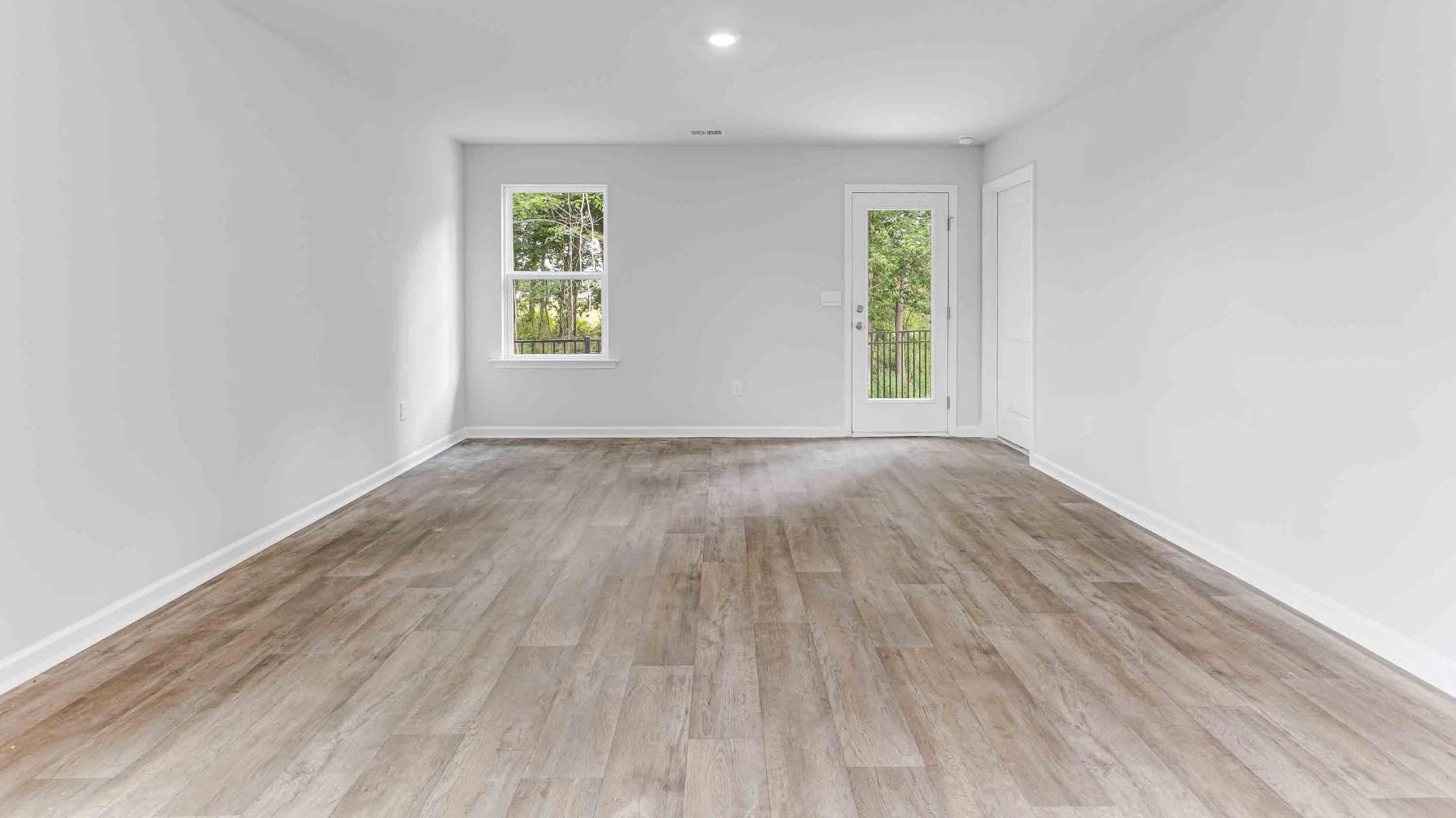 The kitchen features shaker-style cabinets, granite countertops, and stainless steel appliances, which are sure to both turn heads and make meal prep easy. You’ll never be too far from the action with the living and dining area right there.