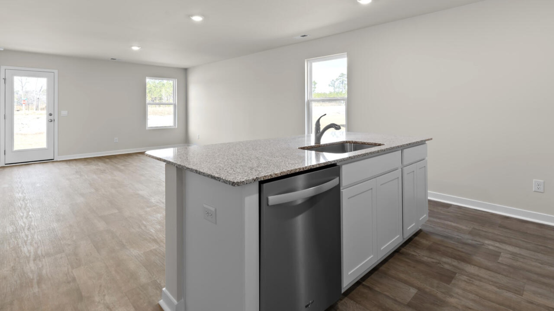 The kitchen features shaker-style cabinets, granite countertops, and stainless steel appliances, which are sure to both turn heads and make meal prep easy.
