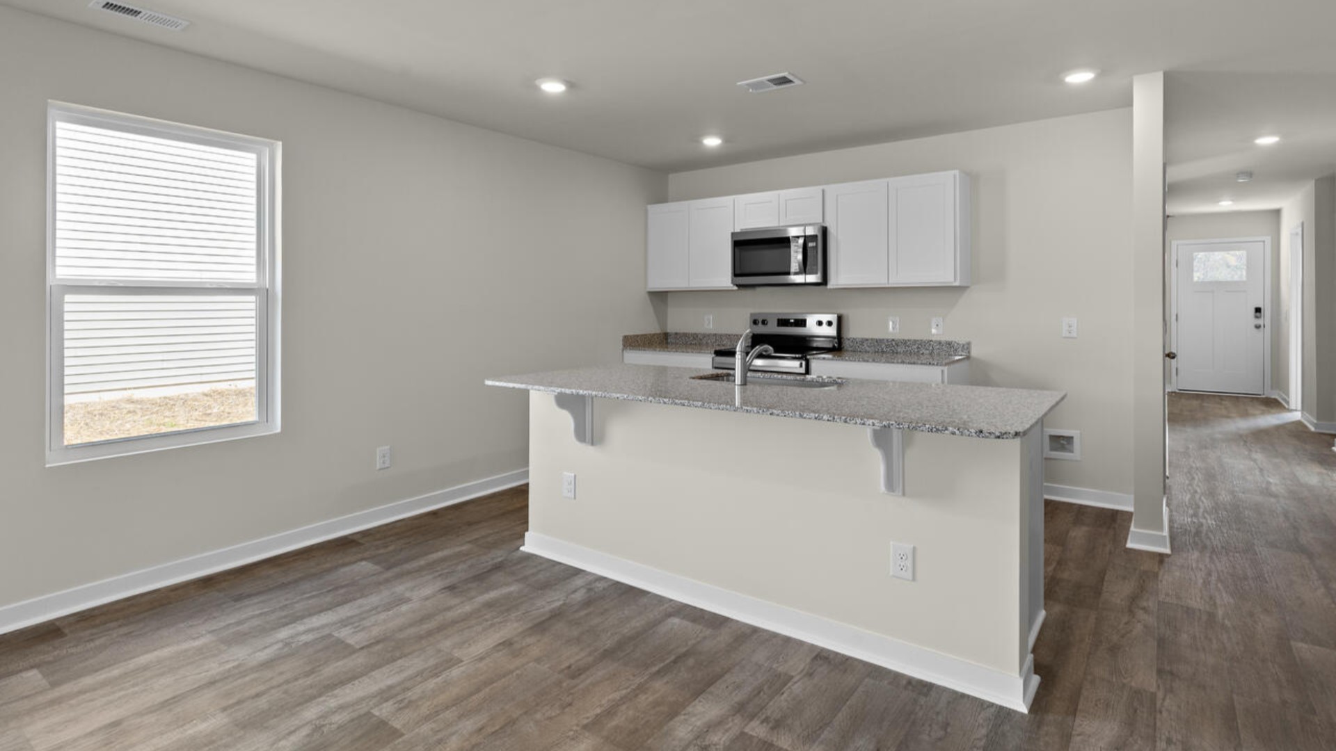 The kitchen features shaker-style cabinets, granite countertops, and stainless steel appliances, which are sure to both turn heads and make meal prep easy.