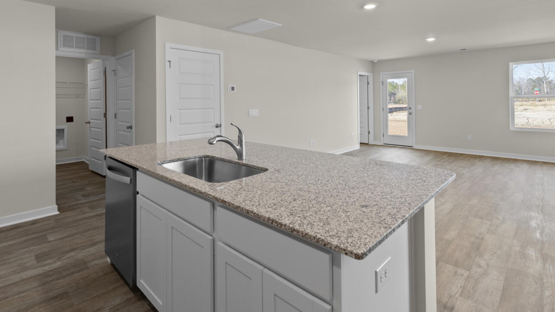 The kitchen features shaker-style cabinets, granite countertops, and stainless steel appliances, which are sure to both turn heads and make meal prep easy.