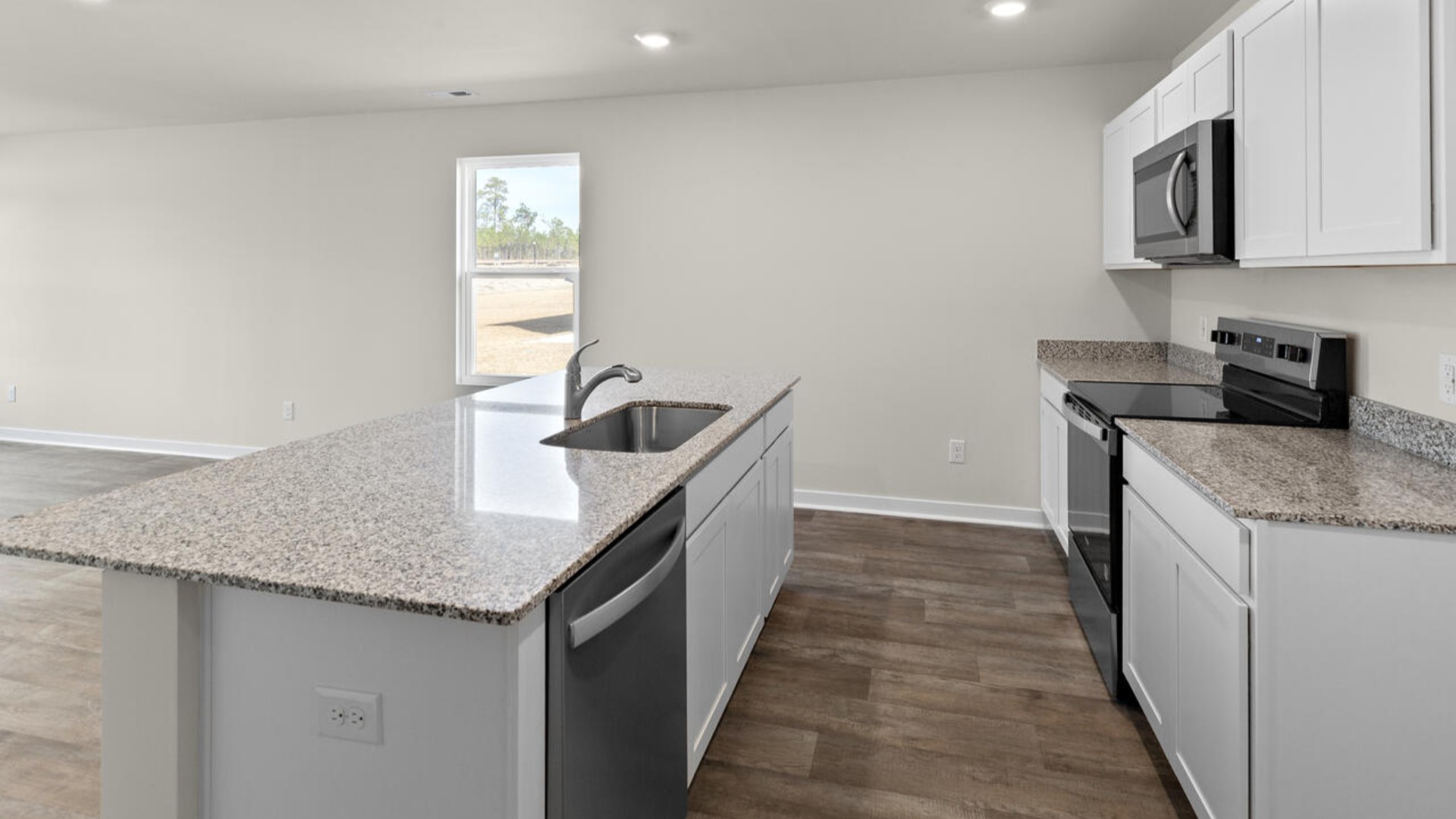 The kitchen features shaker-style cabinets, granite countertops, and stainless steel appliances, which are sure to both turn heads and make meal prep easy.