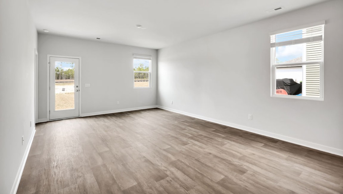 The Devon floor plan offers a spacious open-concept layout that seamlessly connects the living room and kitchen, creating an ideal space for entertaining.