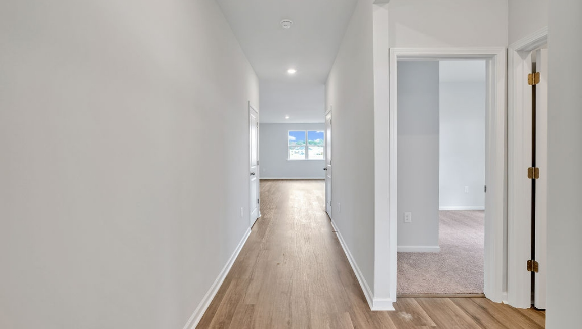 At the front are two guest bedrooms and a full bathroom, perfect for visitors or a home office.