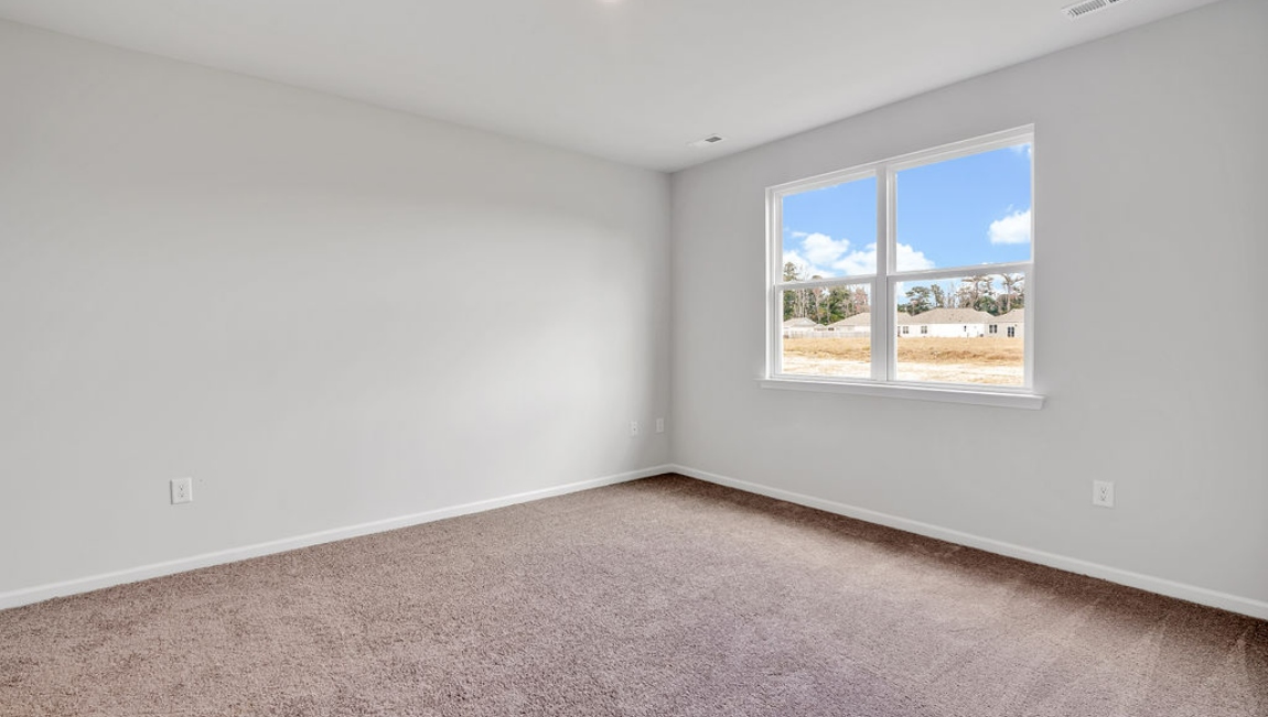 At the back, the Primary Suite provides privacy with a large walk-in closet and walk-in shower. This floor plan combines comfort and convenience, making it a great choice for those seeking an open layout.