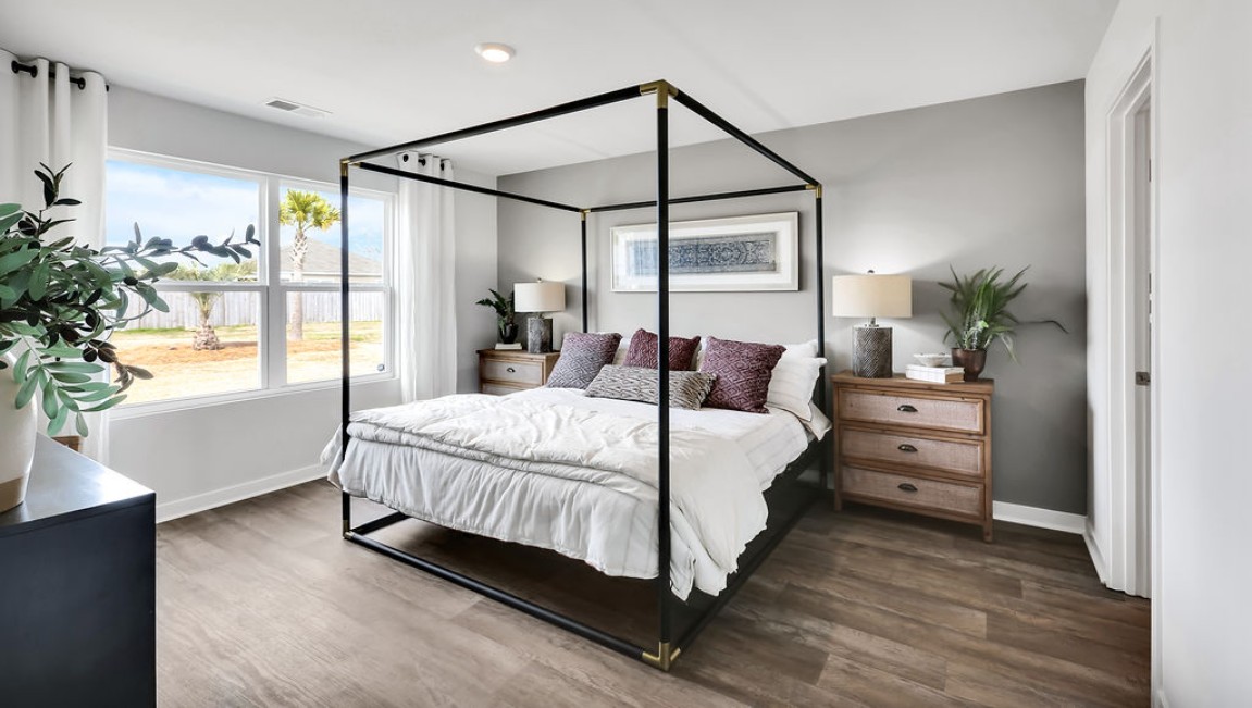 At the back, the Primary Suite provides privacy with a large walk-in closet and walk-in shower. This floor plan combines comfort and convenience