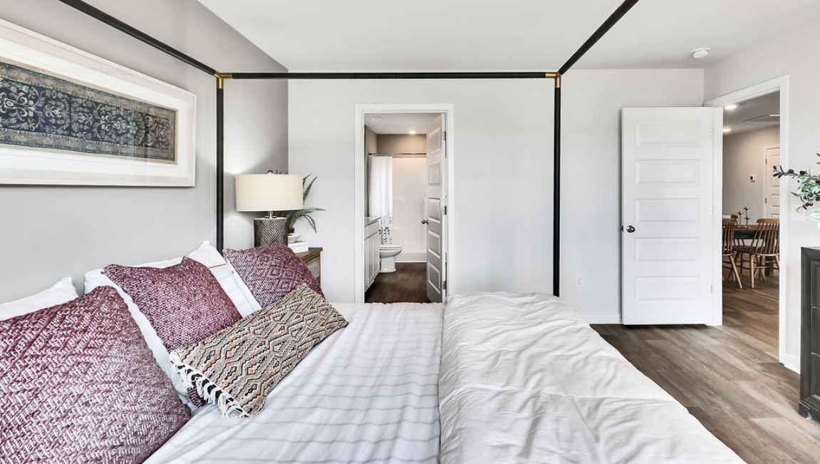 At the back, the Primary Suite provides privacy with a large walk-in closet and walk-in shower. This floor plan combines comfort and convenience