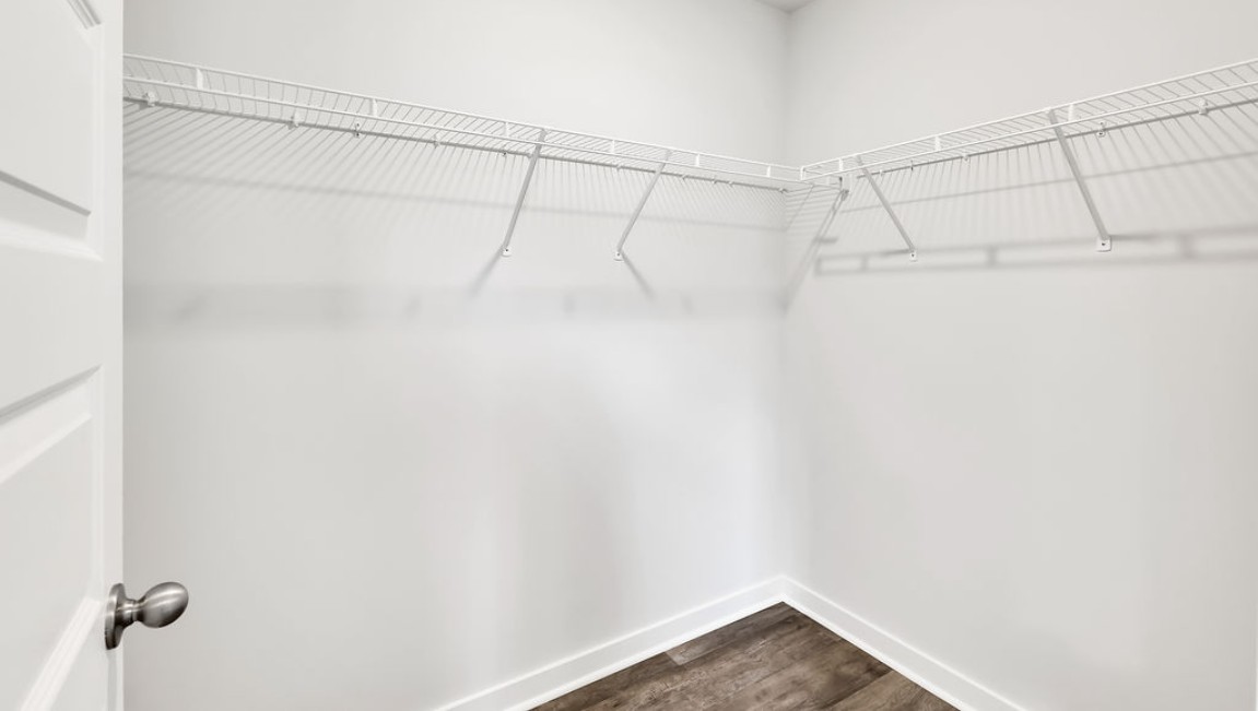 At the back, the Primary Suite provides privacy with a large walk-in closet and walk-in shower. This floor plan combines comfort and convenience