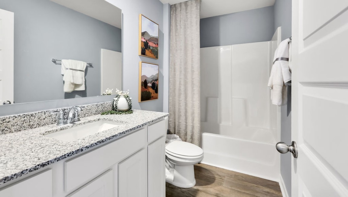 At the front are two guest bedrooms and a full bathroom, perfect for visitors or a home office.