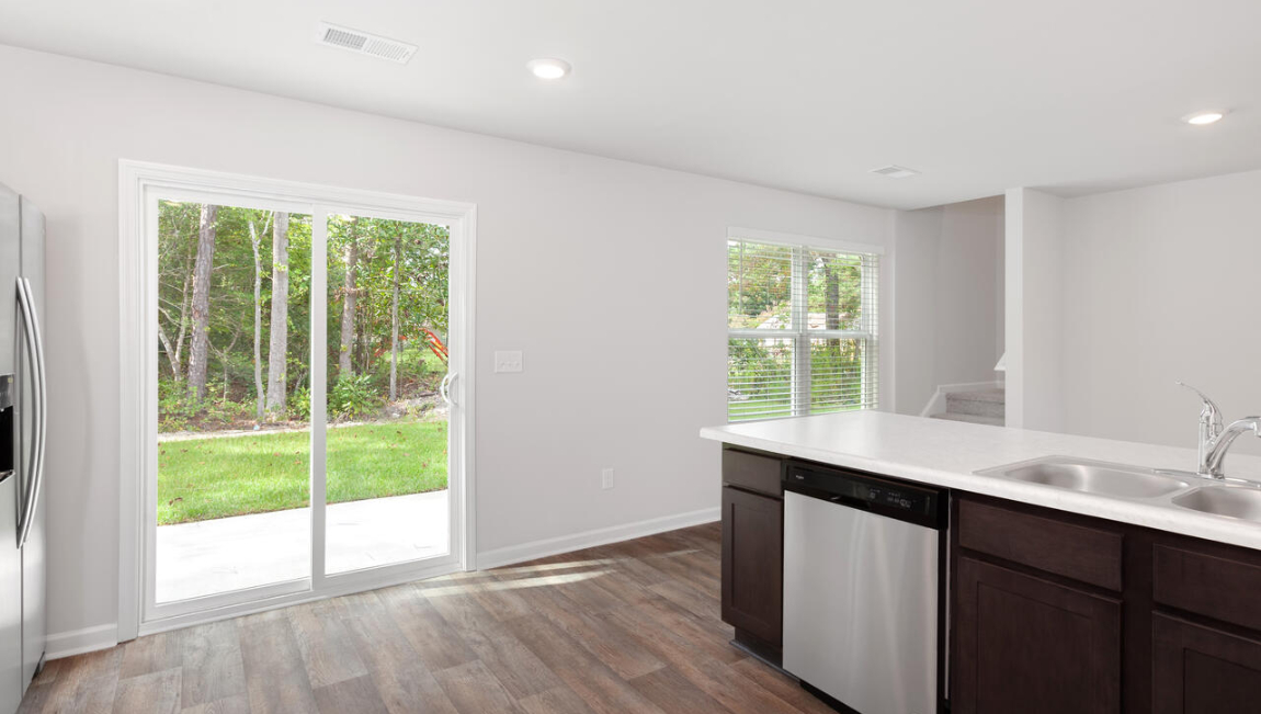 The kitchen features shaker-style cabinets, quartz countertops, and stainless steel appliances, which are sure to both turn heads and make meal prep easy. You’ll never be too far from the action with the living and dining area right there.