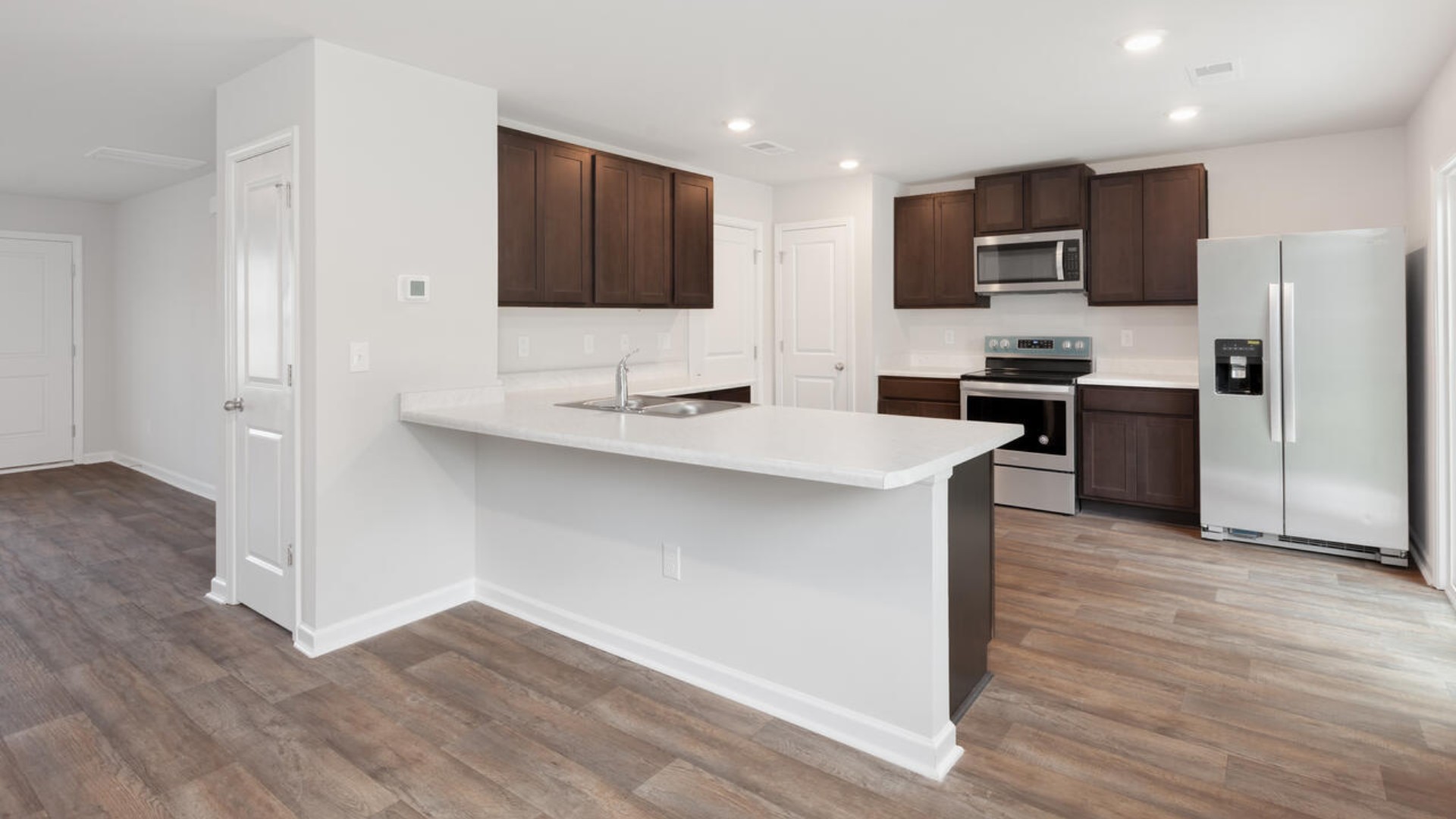 The Brandon offers an open floorplan where the great room leads into the dining room. The adjoining kitchen has a breakfast bar and pantry. Primary Suite with Deluxe Bath. Walk in closet off Primary Bath.