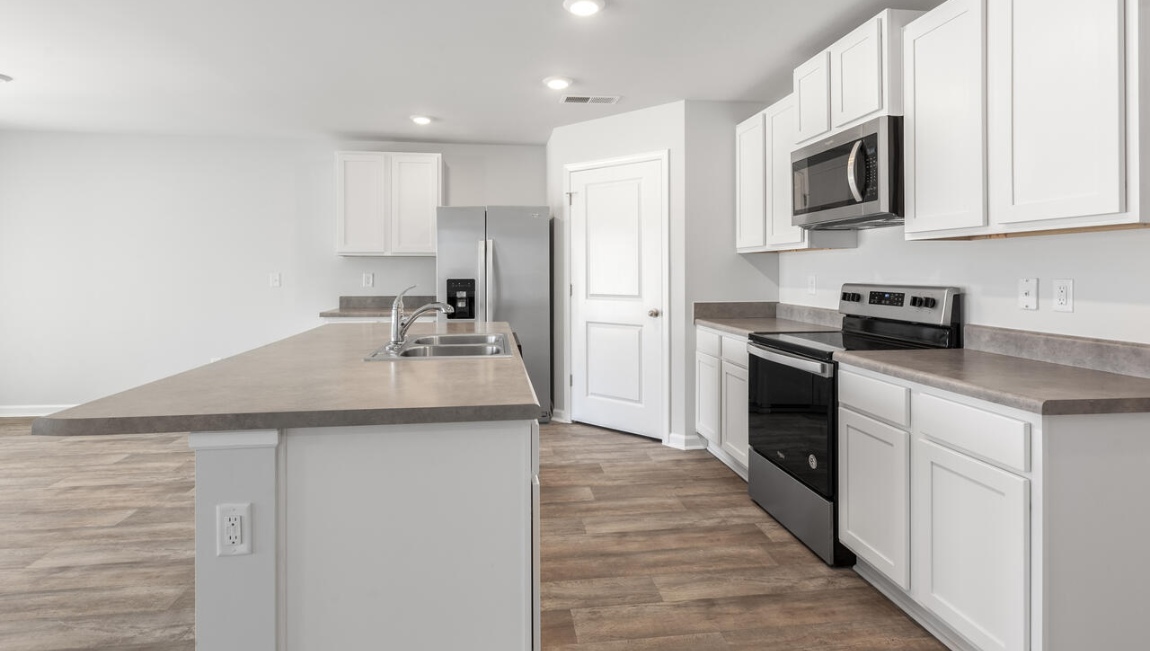 The kitchen features shaker-style cabinets, granite countertops, and stainless-steel appliances, which are sure to both turn heads and make meal prep easy. You’ll never be too far from the action with the living and dining area right there.