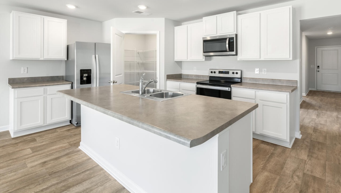 The kitchen features shaker-style cabinets, granite countertops, and stainless-steel appliances, which are sure to both turn heads and make meal prep easy. You’ll never be too far from the action with the living and dining area right there.