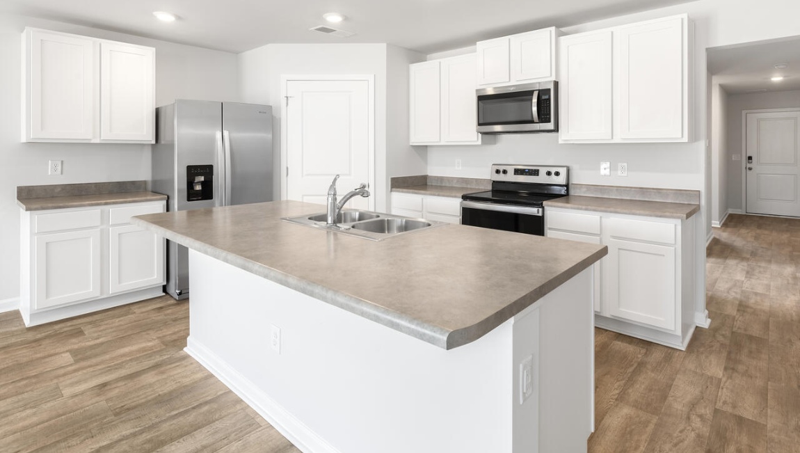 The kitchen features shaker-style cabinets, granite countertops, and stainless-steel appliances, which are sure to both turn heads and make meal prep easy. You’ll never be too far from the action with the living and dining area right there.