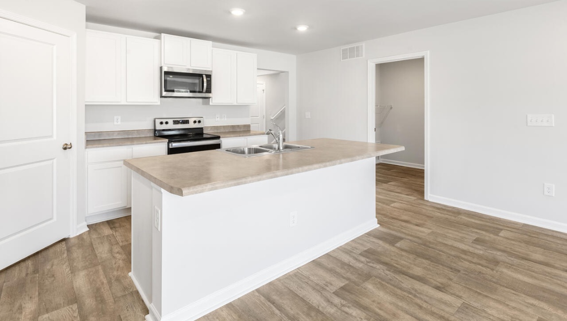The kitchen features shaker-style cabinets, granite countertops, and stainless-steel appliances, which are sure to both turn heads and make meal prep easy. You’ll never be too far from the action with the living and dining area right there.
