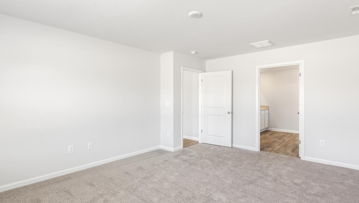 The primary bedroom has its own attached bathroom that features a walk-in closet and all the space you need to get ready in the morning.