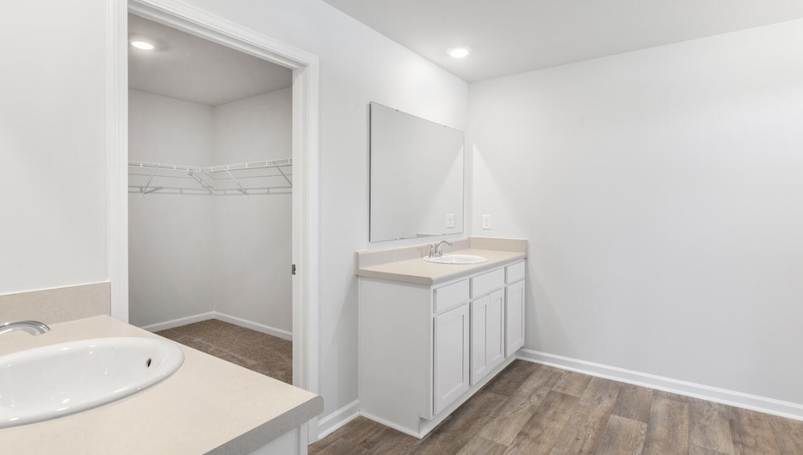 The primary bedroom has its own attached bathroom that features a walk-in closet and all the space you need to get ready in the morning.