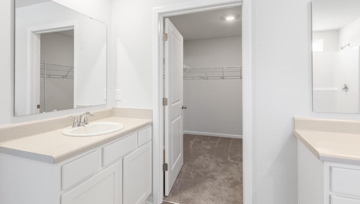The primary bedroom has its own attached bathroom that features a walk-in closet and all the space you need to get ready in the morning.