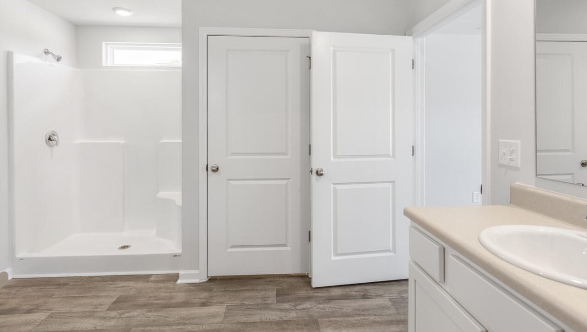 The primary bedroom has its own attached bathroom that features a walk-in closet and all the space you need to get ready in the morning.