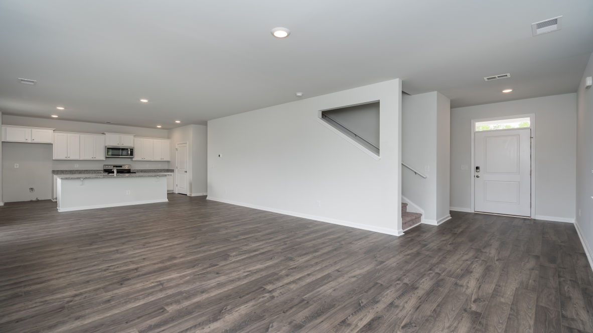 The kitchen features stainless steel appliances, granite countertops an extra-large pantry, a lot of cabinet space, and an efficient layout that is open to the dining and family room.