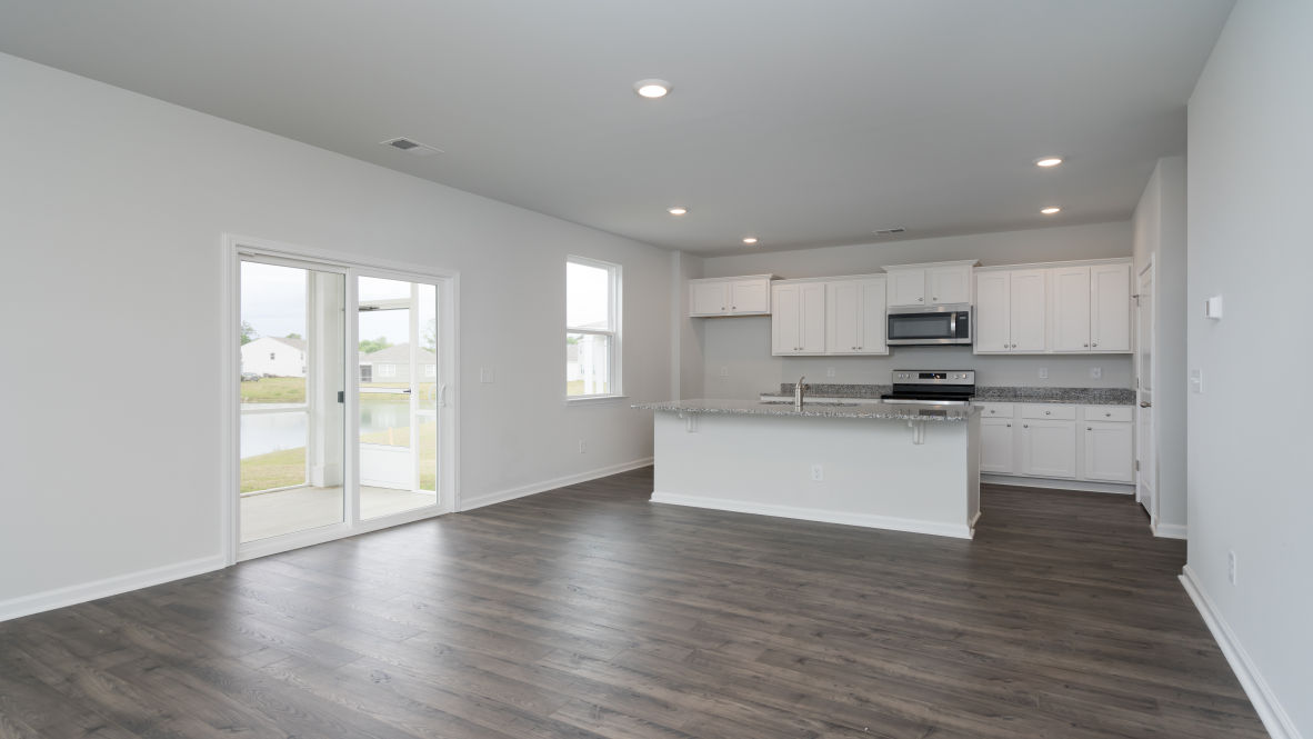 The kitchen features stainless steel appliances, granite countertops an extra-large pantry, a lot of cabinet space, and an efficient layout that is open to the dining and family room.