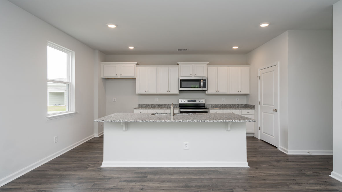 The kitchen island is the perfect size for meal prep with a built-in sink and dishwasher.