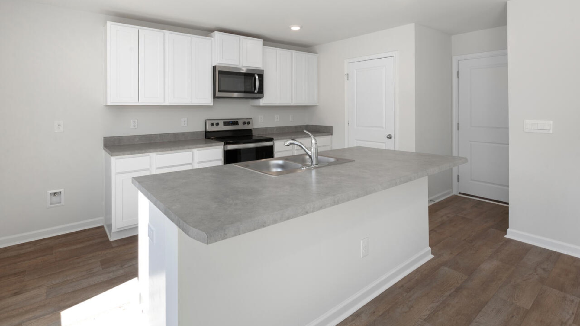 The kitchen features stainless steel appliances, granite countertops an extra-large pantry, a lot of cabinet space, and an efficient layout that is open to the dining and family room. The kitchen island is the perfect size for meal prep with a built-in sink and dishwasher.