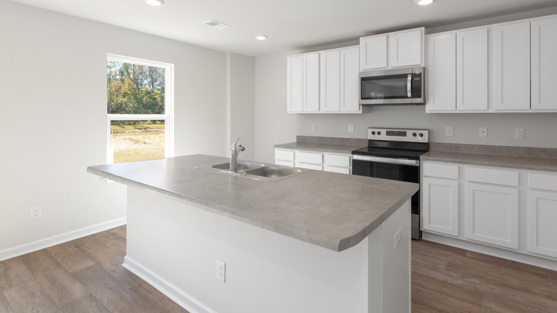 The kitchen features stainless steel appliances, granite countertops an extra-large pantry, a lot of cabinet space, and an efficient layout that is open to the dining and family room. The kitchen island is the perfect size for meal prep with a built-in sink and dishwasher.
