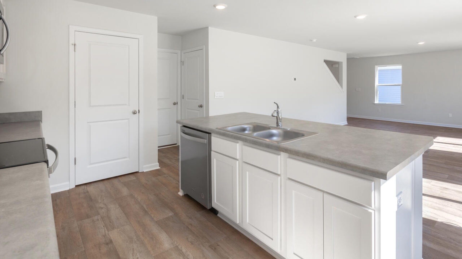 The kitchen features stainless steel appliances, granite countertops an extra-large pantry, a lot of cabinet space, and an efficient layout that is open to the dining and family room. The kitchen island is the perfect size for meal prep with a built-in sink and dishwasher.