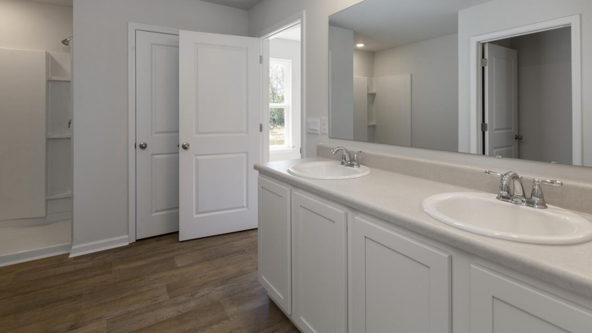 The primary bedroom is a perfect retreat with a walk-in closet and generous primary bathroom featuring a double vanity, large shower, and a separate linen closet. Plus, the laundry room is on the second floor with all the bedrooms!