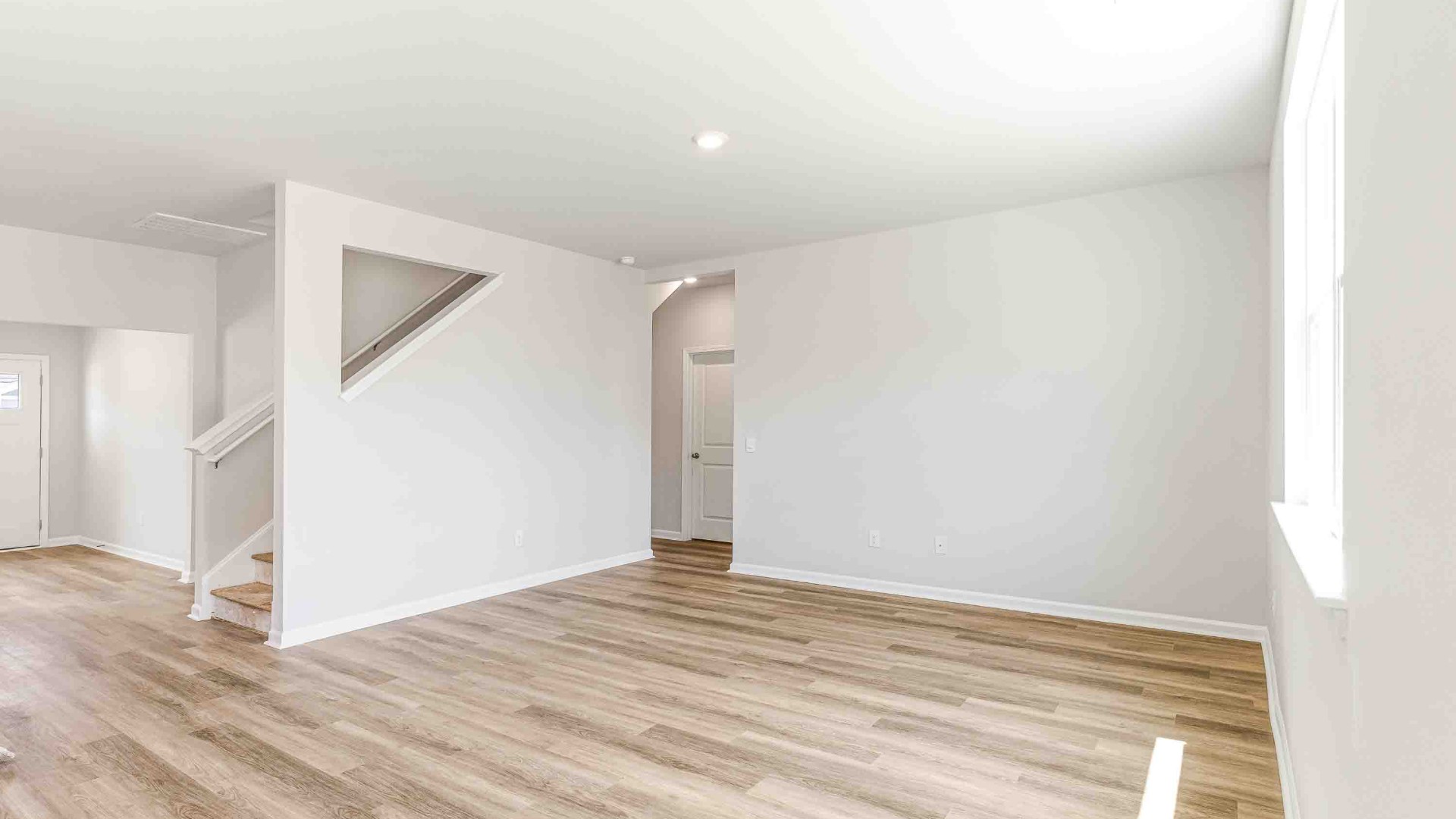 The upstairs has an additional living space, a laundry room, and a Primary Bedroom.