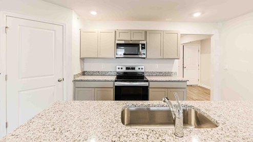 kitchen equipped with Stainless Steel Appliances, including a smooth-top electric range, microwave, granite countertop, dishwasher.