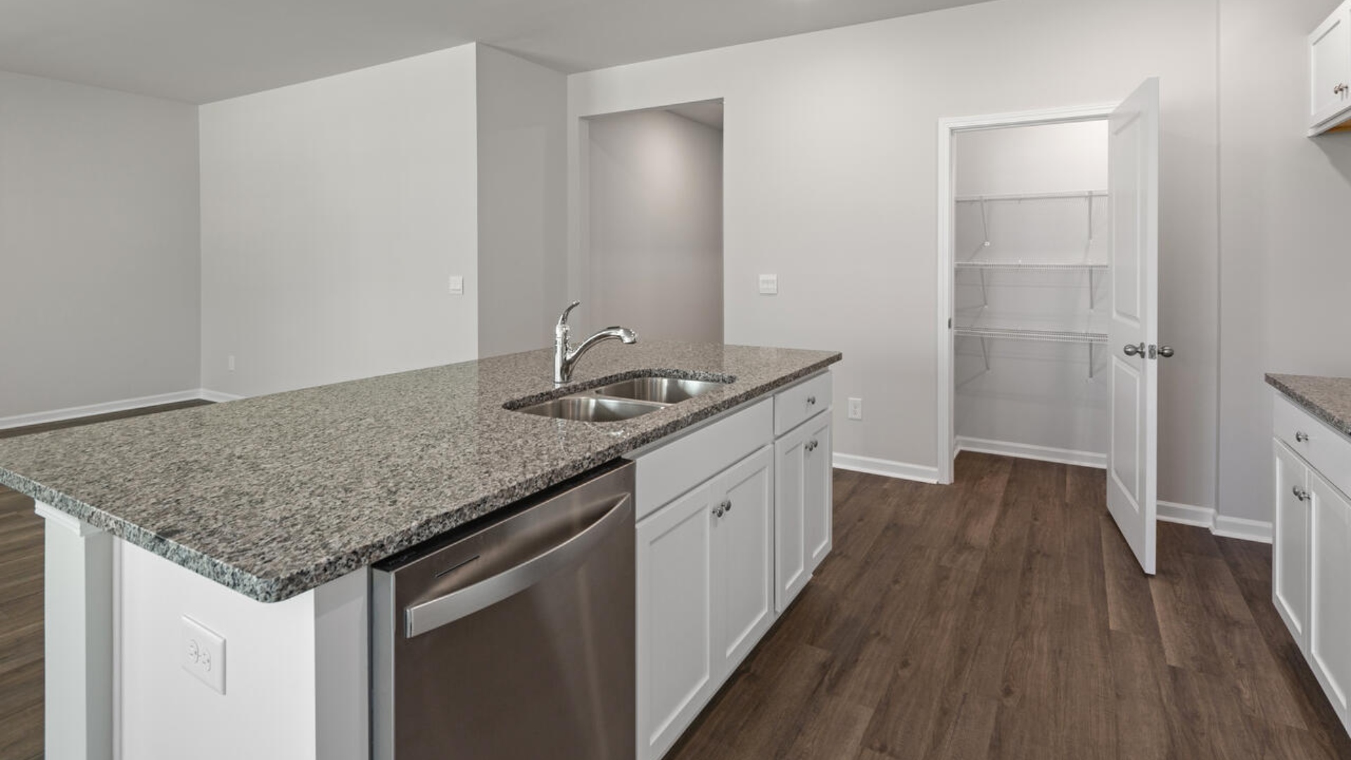 The kitchen features a large island, granite countertops, and stainless steel appliances, which are sure to both turn heads and make meal prep easy. You’ll never be too far from the action with the living and dining area right there.
