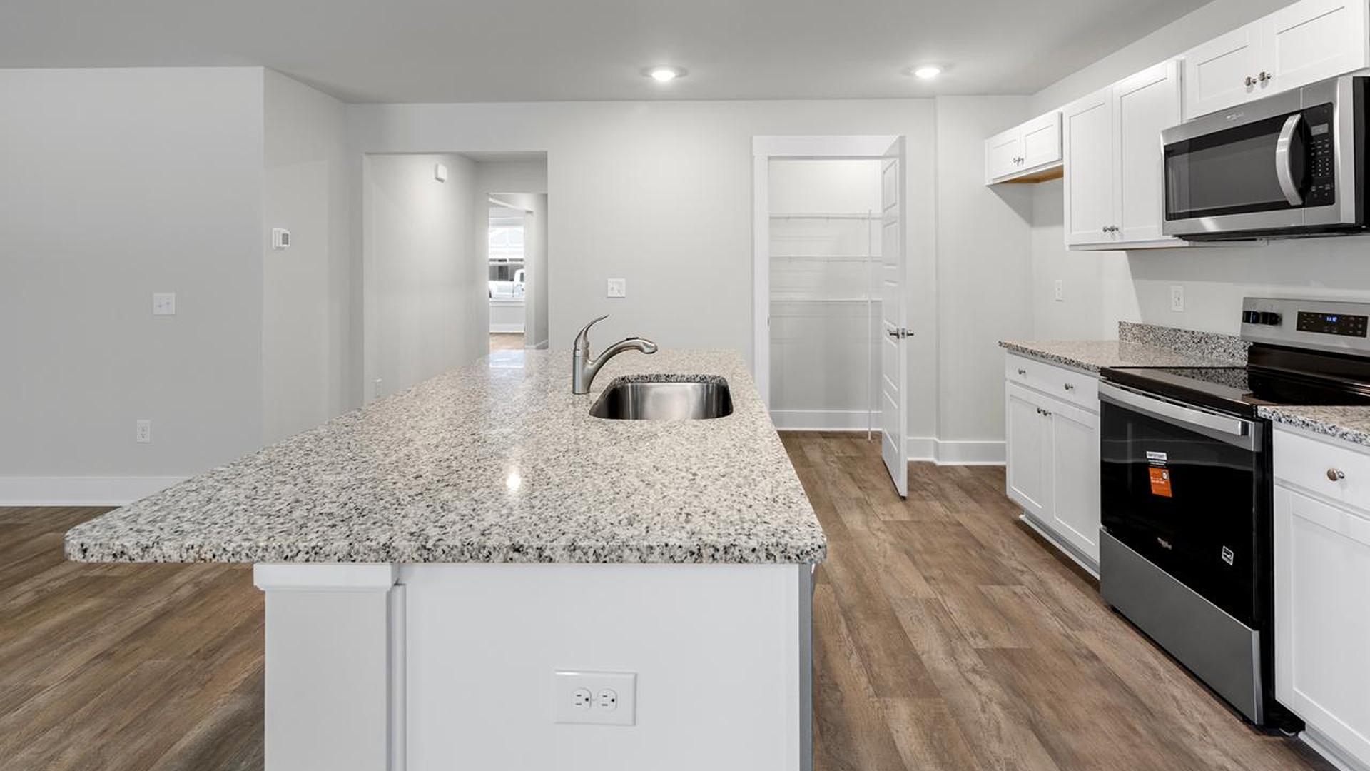 The kitchen features a large island, granite countertops, and stainless-steel appliances, which are sure to both turn heads and make meal prep easy. Y The kitchen features a large island, granite countertops, and stainless-steel appliances, which are sure to both turn heads and make meal prep easy. Y