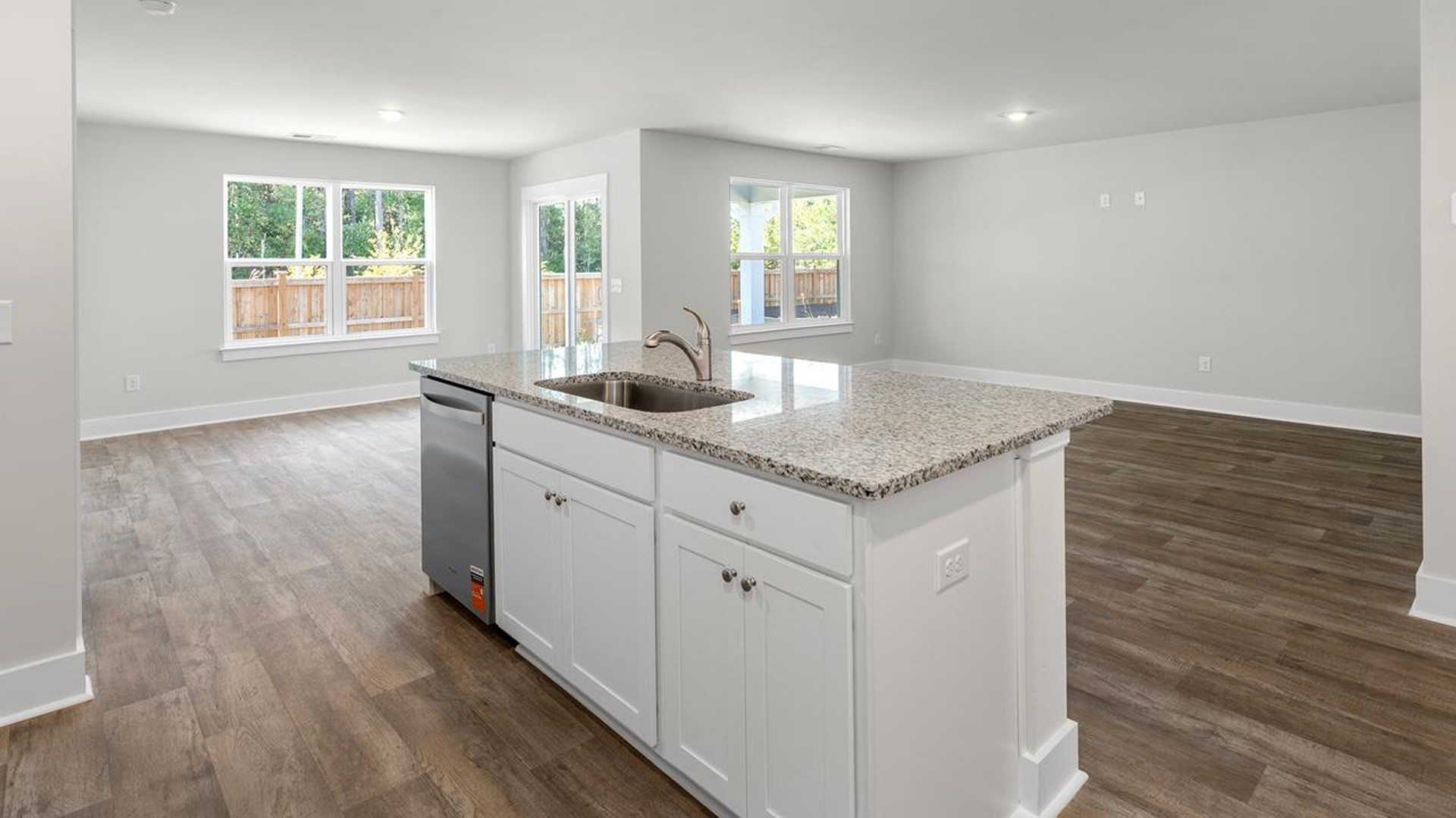 The kitchen features a large island, granite countertops, and stainless-steel appliances, which are sure to both turn heads and make meal prep easy. You’ll never be too far from the action with the living and dining area right there.